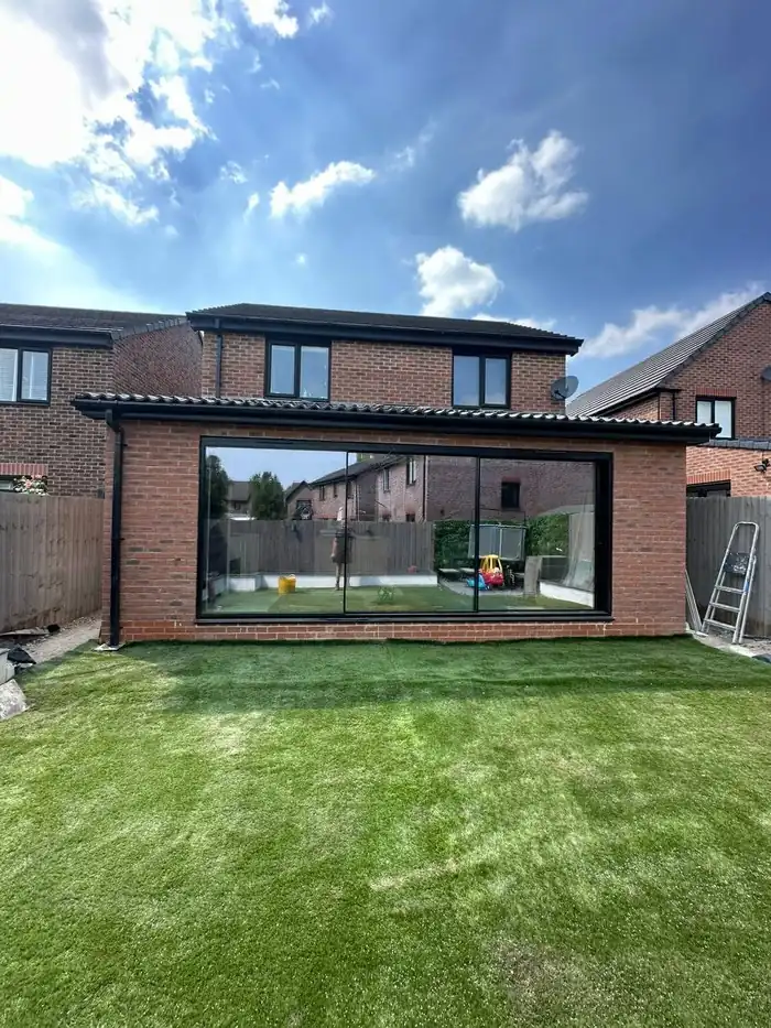 Finished rear extension with sliding doors opening onto the lawn